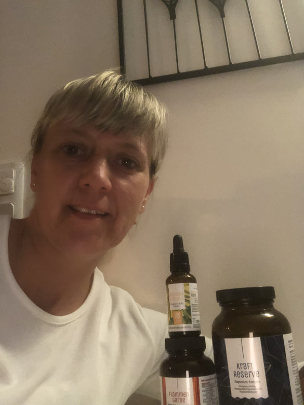 Zufriedene Kundin zeigt NATURTREU Sonnenfreund Vitamin D3 K2 Tropfen.